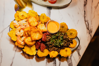 Spanish-inspired sampler platter with tostones, shrimp, chorizo and steak at District385
