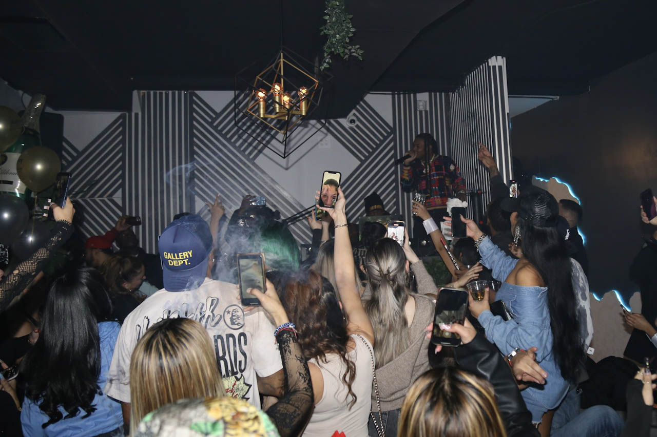 The crowd with hands and phones up during a set at District385