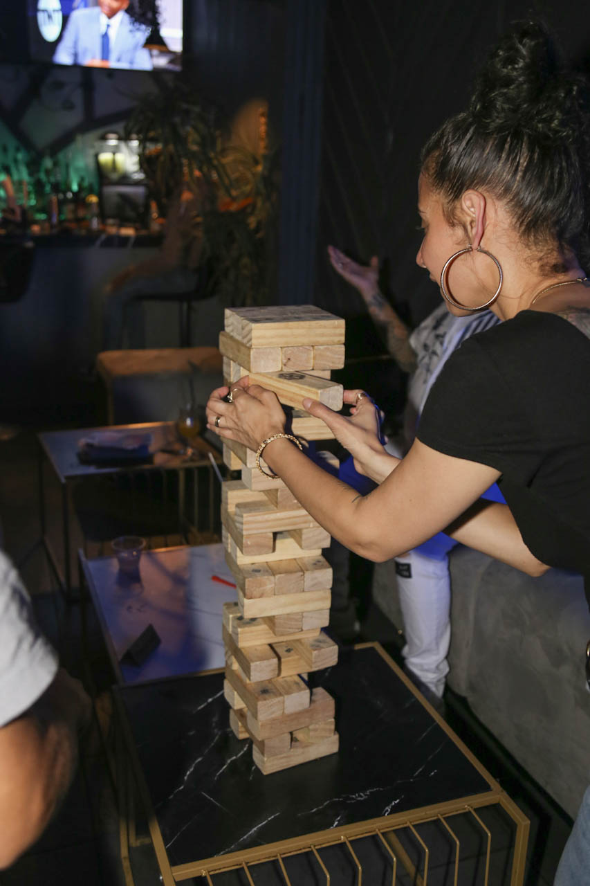 Guests playing a giant Jenga table game at District385