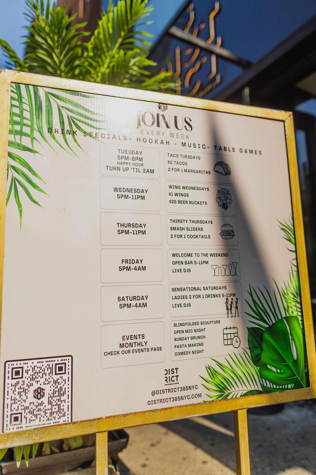 District385 sign listing weekly hours, hookah, music and table games