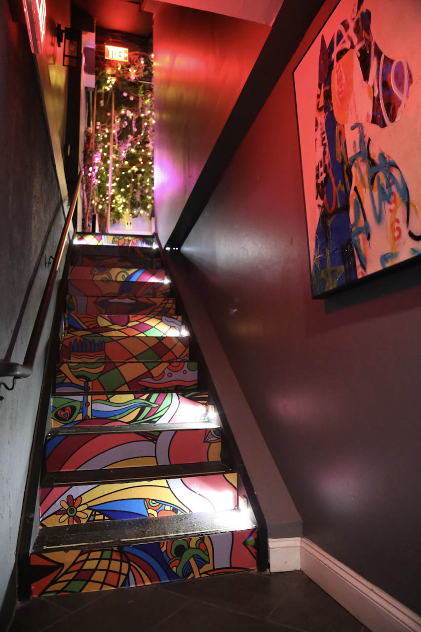 Painted mural along the stairwell leading into District385