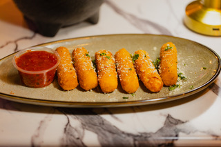 Golden fried cheese sticks with marinara dipping sauce at District385