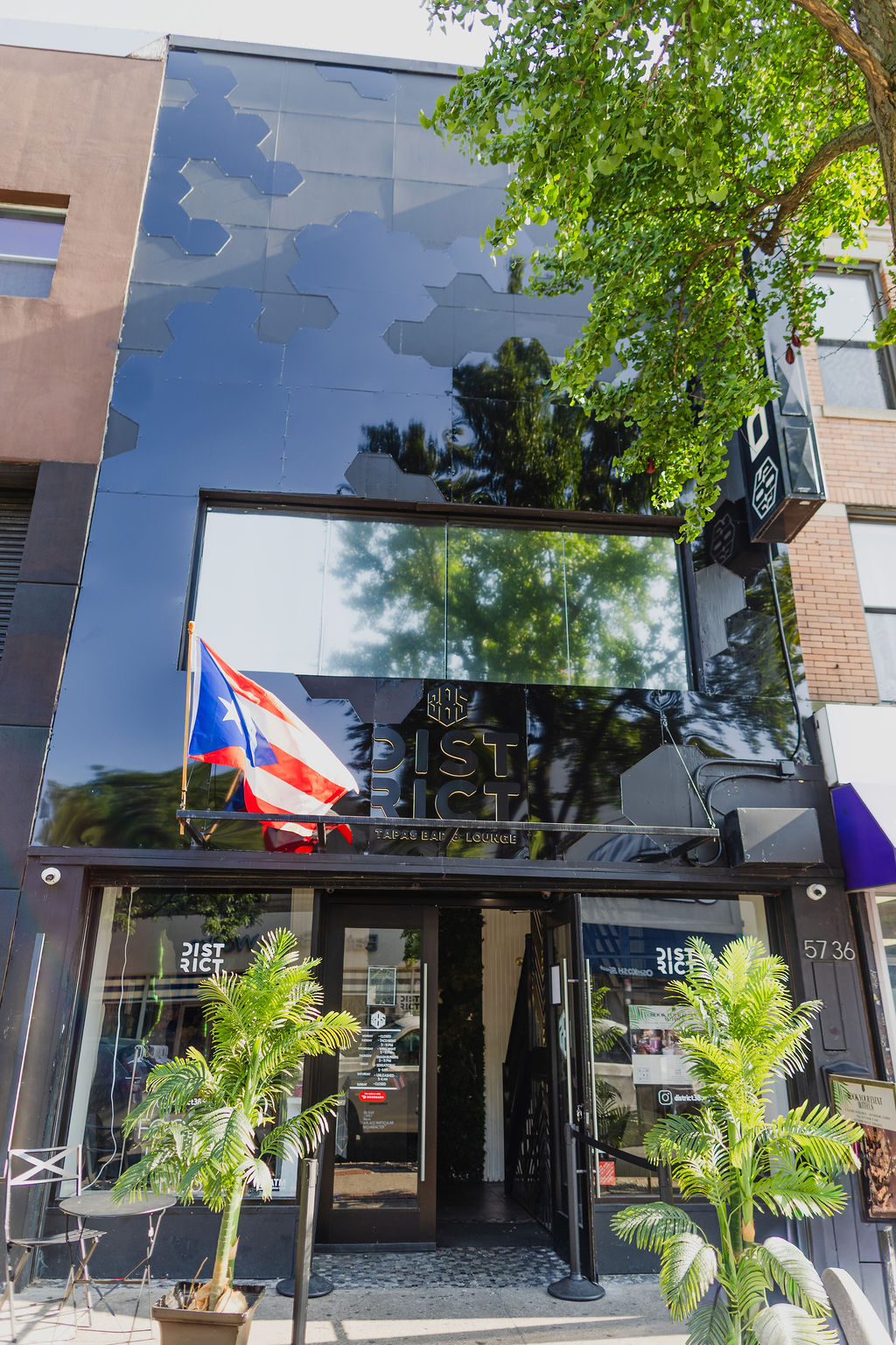 Mirrored glass facade of District385 reflecting Ridgewood