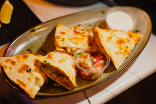 Chicken quesadilla with pico de gallo and sour cream at District385